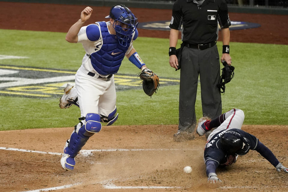 Atlanta Braves' Nick Markakis scores past Los Angeles Dodgers catcher Will Smith on a double by Cristian Pache during the fifth inning in Game 2 of a baseball National League Championship Series Tuesday, Oct. 13, 2020, in Arlington, Texas. (AP Photo/Tony Gutierrez)