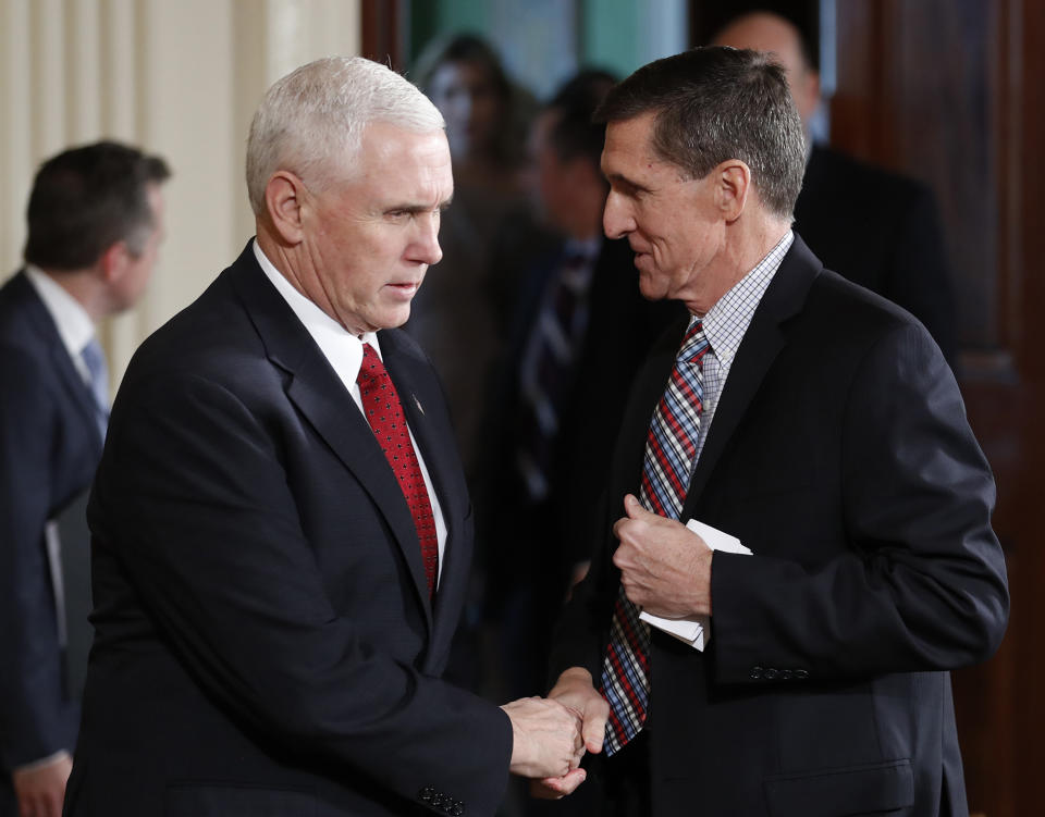 Vice President Mike Pence and then national security adviser Michael Flynn, right, shake hands before the start of the joint news conference by President Trump and Japanese Prime Minister Shinzo Abe in the East Room of the White House in Washington, D.C., on Feb. 10, 2017. (Photo: Carolyn Kaster/AP)