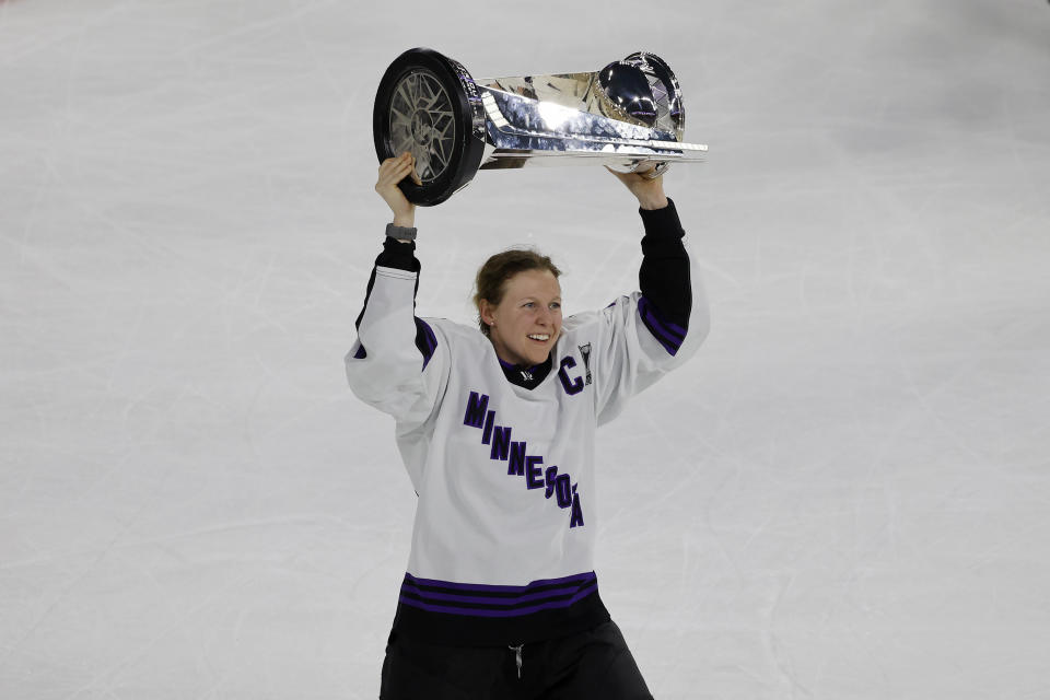 Minnesota captain Kendall Coyne Schofield celebrates with the trophy after beating Boston in Game 5 of the PWHL Walter Cup hockey finals, Wednesday May 29, 2024, in Lowell, Mass. (AP Photo/Mary Schwalm)