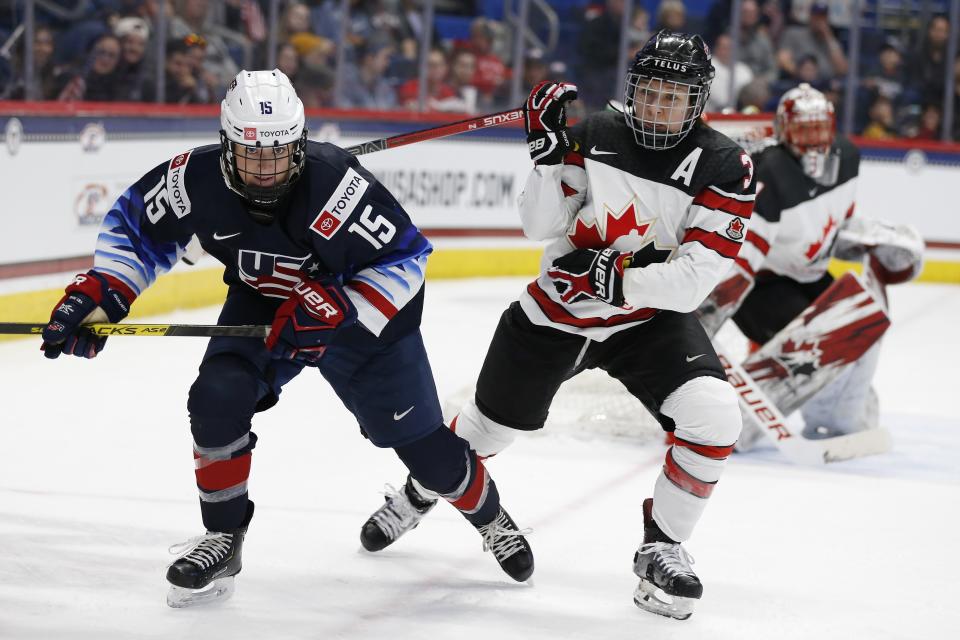 Canada's Jocelyne Larocque (3) defends against United States' Sydney Brodt (15) during the first period of a rivalry series women's hockey game in Hartford, Conn., Saturday, Dec. 14, 2019. (AP Photo/Michael Dwyer)