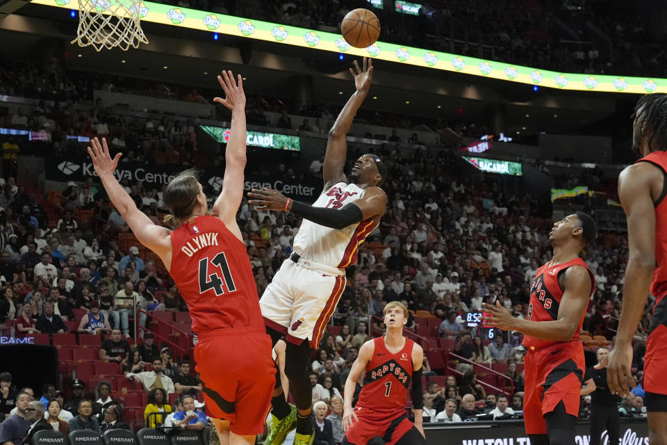 Miami Heat center Bam Adebayo (13) aims to score as Toronto Raptors forward Kelly Olynyk (41) defends during the first half of an NBA basketball game, Friday, April 12, 2024, in Miami. (AP Photo/Marta Lavandier)