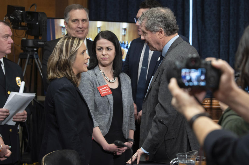 FILE - Sen. Sherrod Brown, D-Ohio, right, talks with East Palestine residents Jessica Conard, left, and Misti Allison, center, before a Senate Environment and Public Works Committee hearing to examine protecting public health and the environment in the wake of the Norfolk Southern train derailment in East Palestine, March 9, 2023, in Washington. (AP Photo/Kevin Wolf, File)