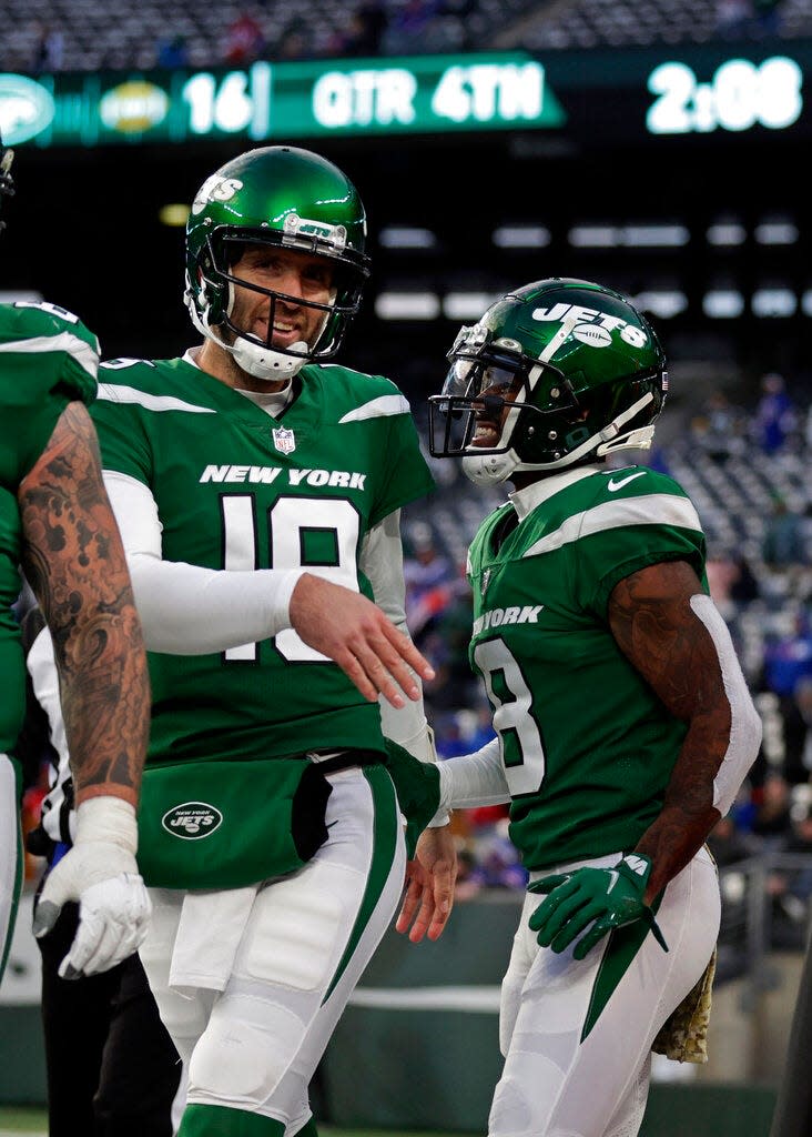 Jets quarterback Joe Flacco (19) celebrates throwing a touchdown pass to wide receiver Elijah Moore (8) against the Buffalo Bills, Nov. 14, 2021, in East Rutherford, N.J.