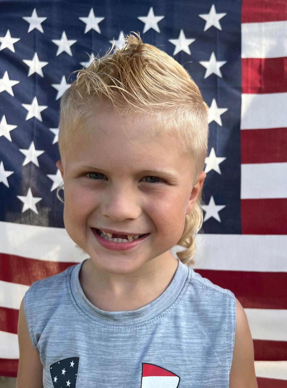 Axel Wenzel, 5, of Brillion, Wisconsin, poses for his submission photo for the USA Mullet Championships.