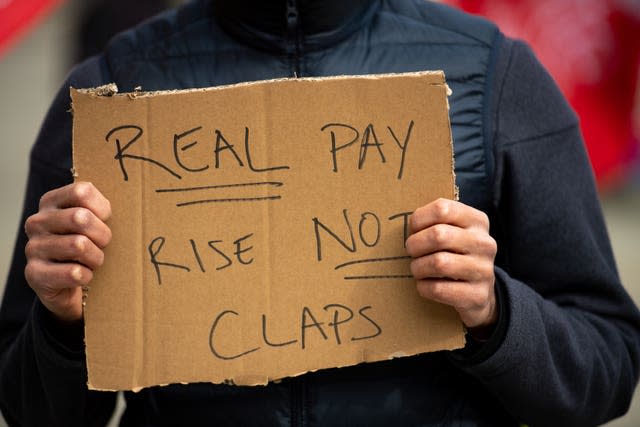 People protesting in St Peter’s Square in Manchester, over the proposed 1% pay rise for NHS workers (Jacob King/PA)