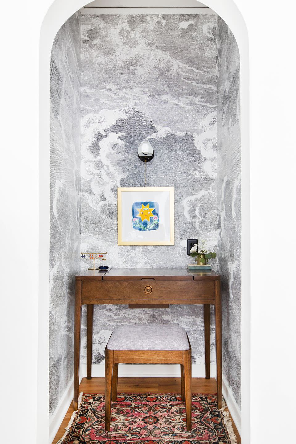 home office alcove in bedroom with cloud wallpaper