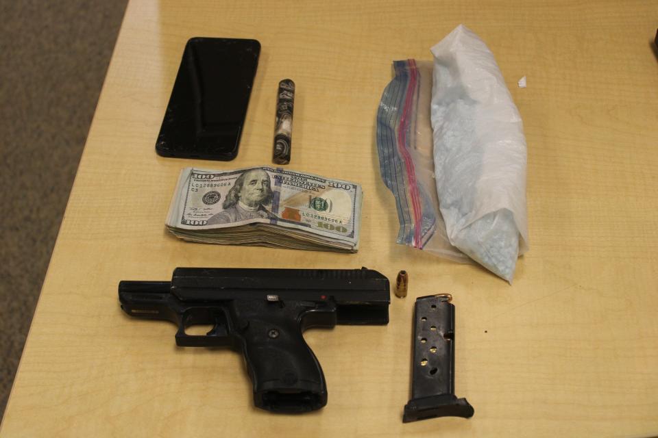 A gun, cash, drugs and various other items taken off a suspect during an arrest