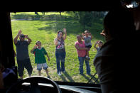 <b>Aug. 14, 2012:</b> "The President waves from his campaign bus to people lining the motorcade route in Iowa." (Official White House Photo by Pete Souza)