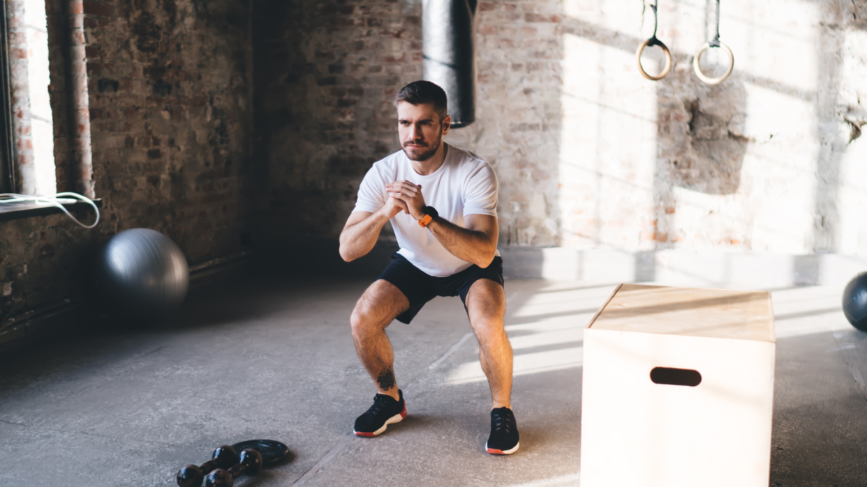  Man doing bodyweight squats. 