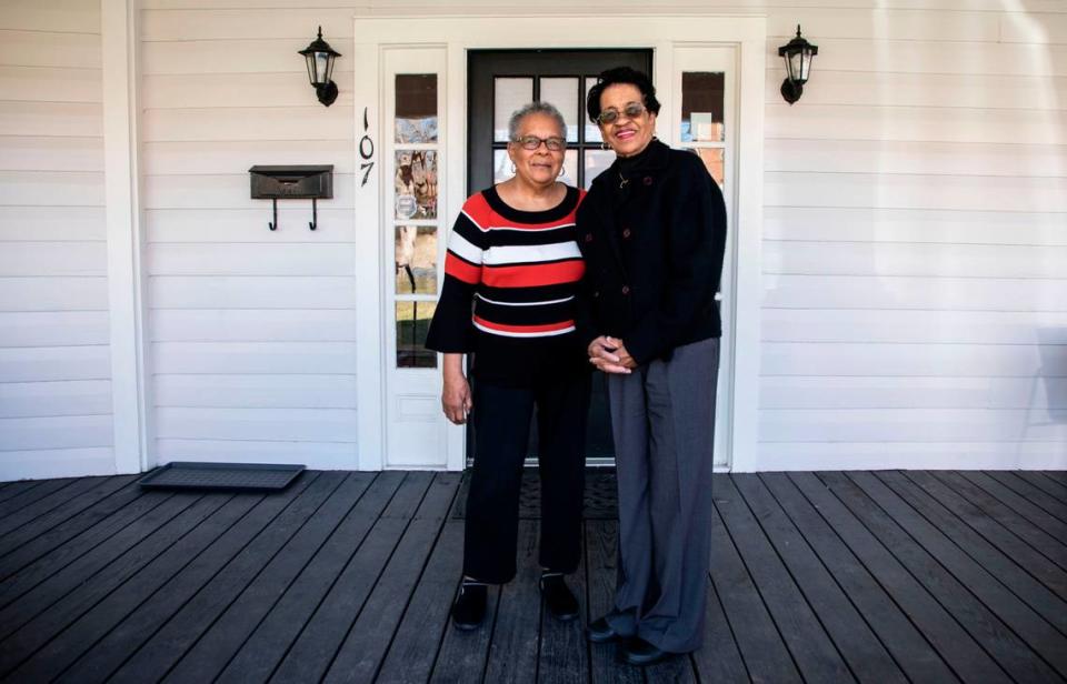 Cousins Dolores Clark, left, and Georgia Bradsher, right, pose for a portrait together on the front porch of William Strayhorn’s house on Jones Ferry Road in Carrboro, N.C. on Feb. 9, 2022. William Strayhorn was Nellie and Toney’s son.