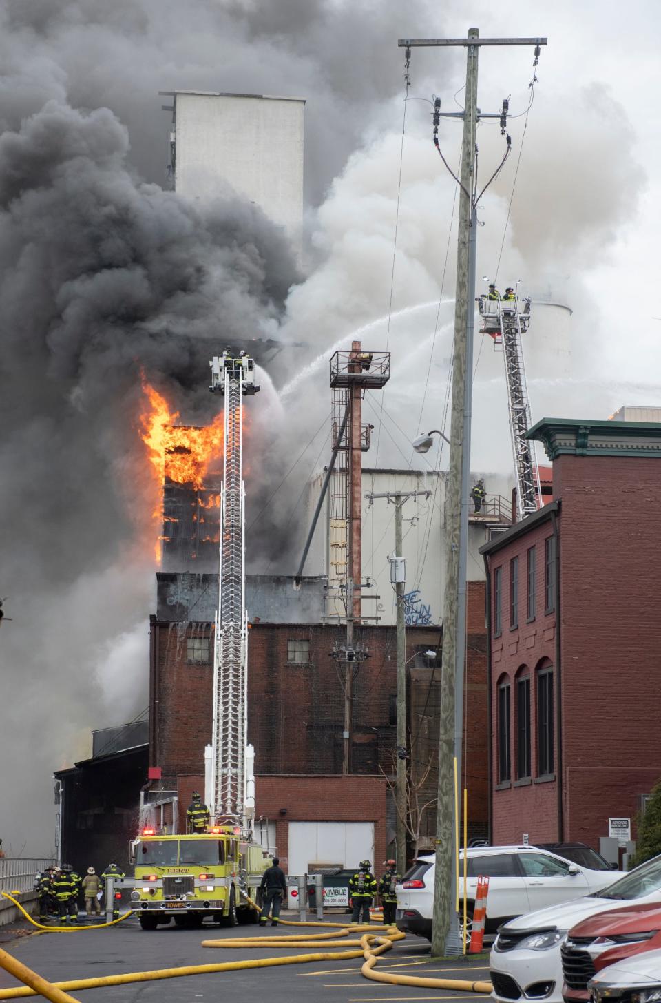 Firefighters battle a major fire Friday morning at the former Star of the West mill complex on North Water Street in Kent.