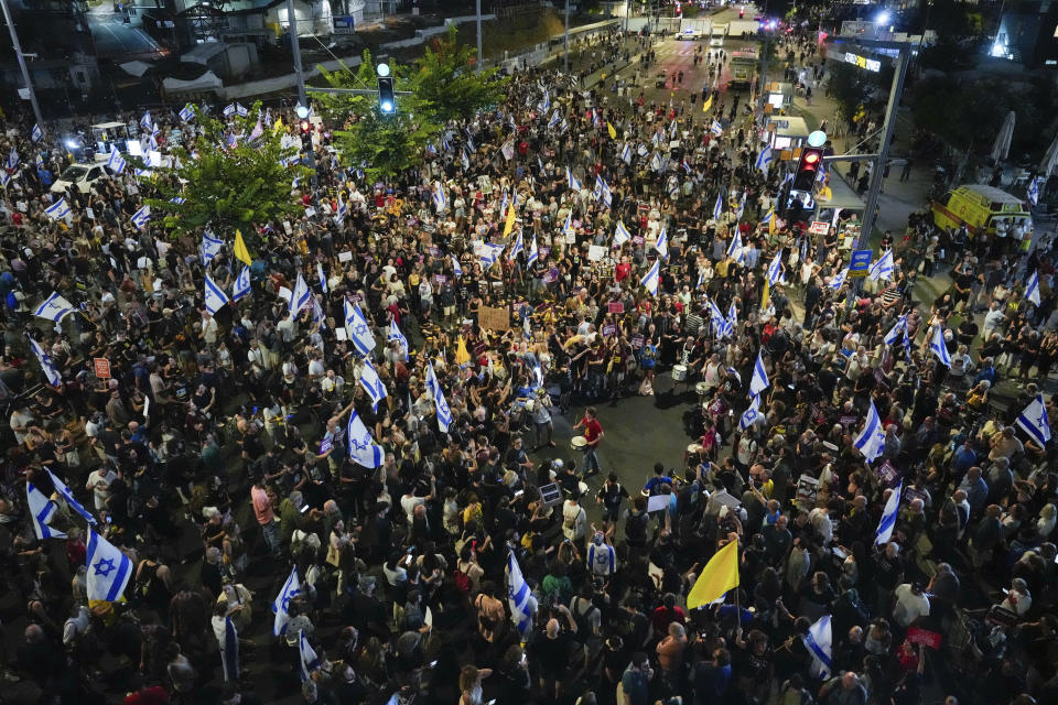 People attend a rally demanding a cease-fire deal and the immediate release of hostages held by Hamas in the Gaza Strip in Tel Aviv, Israel, on Tuesday, Sept. 3, 2024. (AP Photo/Ariel Schalit)