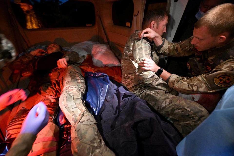 Soldiers get medical treatment inside a vehicle