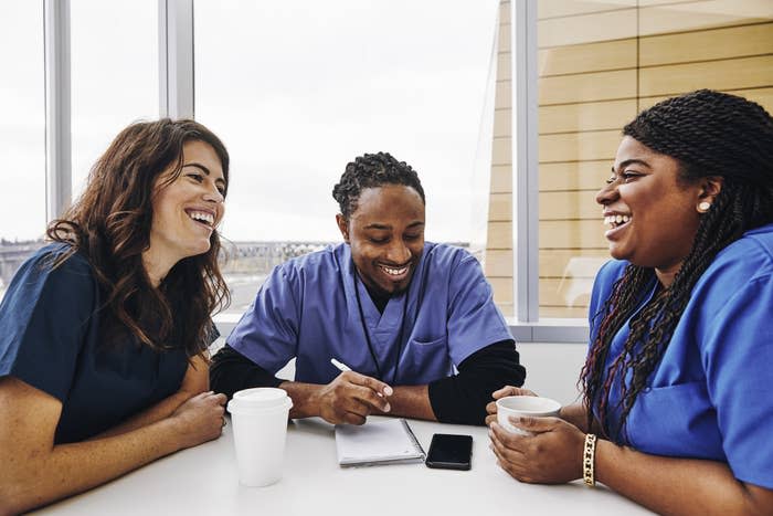 A group of nurse coworkers have a conversation together