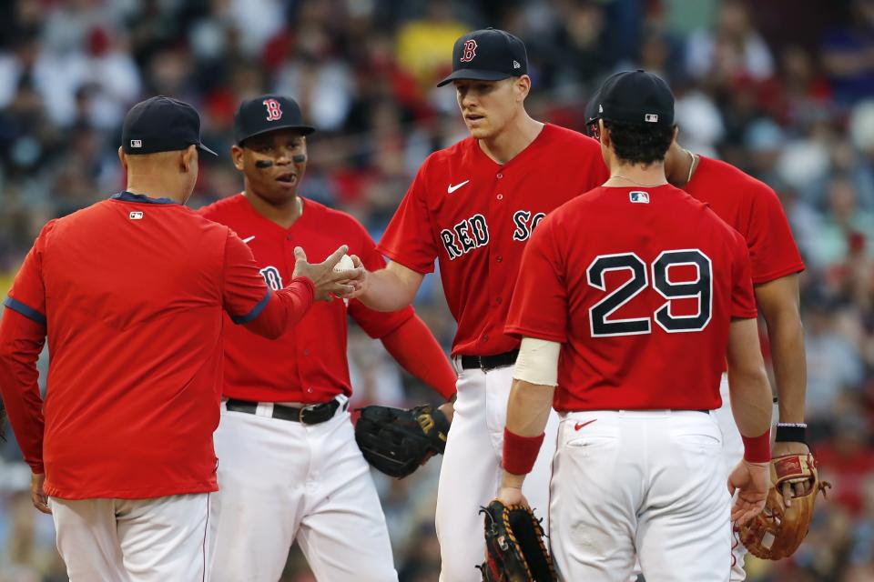 Boston Red Sox manager Alex Cora, left, relieves Nick Pivetta, center, during the sixth inning of a baseball game against the New York Yankees, Saturday, Sept. 25, 2021, in Boston. (AP Photo/Michael Dwyer)