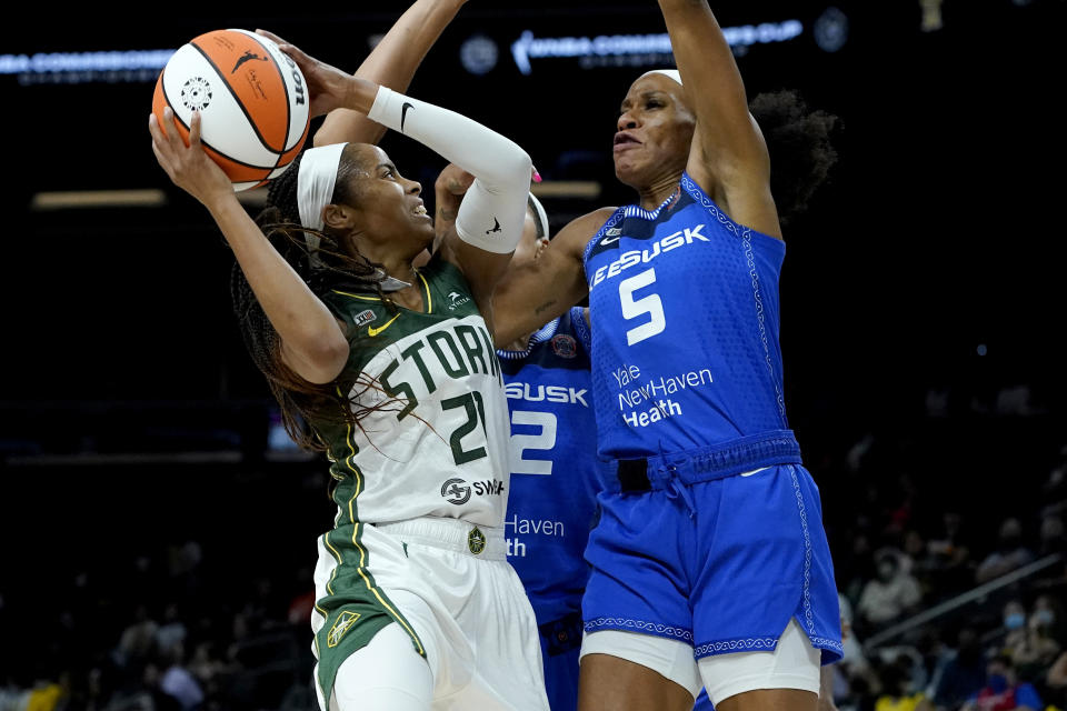 Seattle Storm guard Jordin Canada (21) shoots as Connecticut Sun guard Jasmine Thomas (5) defends during the first half of the Commissioner's Cup WNBA basketball game Thursday, Aug. 12, 2021, in Phoenix. (AP Photo/Matt York)