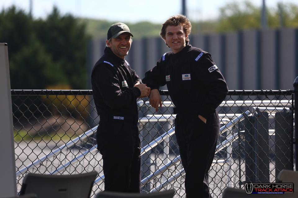 Joe Tegerdine, left, standing with his son, Joseph, while attending classes at the Ford Performance Racing School in Charlotte, North Carolina, in April 2024. They were invited as guests of Ford CEO Jim Farley to each drive a 2024 Ford Mustang Dark Horse on the track.