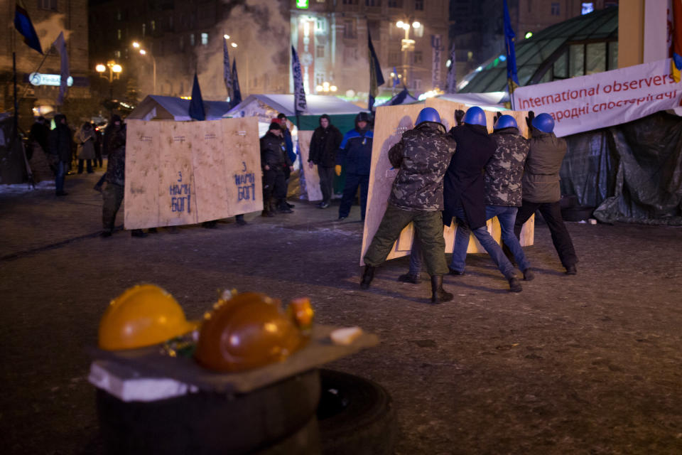 Opposition supporters hold wooden shields as they confront each other during training at Kiev's Independence Square, the epicenter of the country's current unrest, Ukraine, Thursday, Jan. 30, 2014. Ukraine's embattled president Viktor Yanukovych is taking sick leave as the country's political crisis continues without signs of resolution. (AP Photo/Emilio Morenatti)