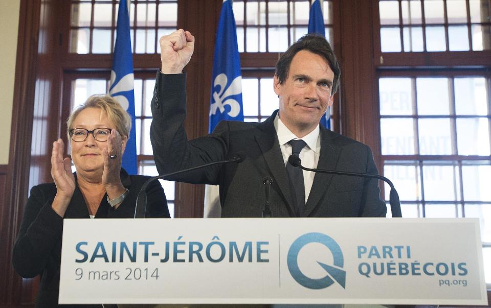 Parti Quebecois leader Pauline Marois looks on as Pierre Karl Peladeau gestures during a press in Saint Jerome, Quebec, Sunday, March 9, 2014. Peladeau has announced his candidacy for the riding of Saint Jerome for the Parti Quebecois on day five of the Quebec provincial election campaign. (AP Photo/The Canadian Press, Graham Hughes)