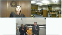 In this image from El Paso County District Court video, Anderson Lee Aldrich, 22, center of bottom screen, is slumped over in a chair during a brief video appearance from jail in Colorado Springs, Colo., Wednesday, Nov. 23, 2022. Aldrich, the alleged shooter is facing possible hate crime charges in the fatal shooting of five people at a Colorado Springs gay nightclub, was ordered held without bail in an initial court appearance Wednesday. At top left is El Paso County Court Judge Charlotte Ankeny. (El Paso County District Court via AP)