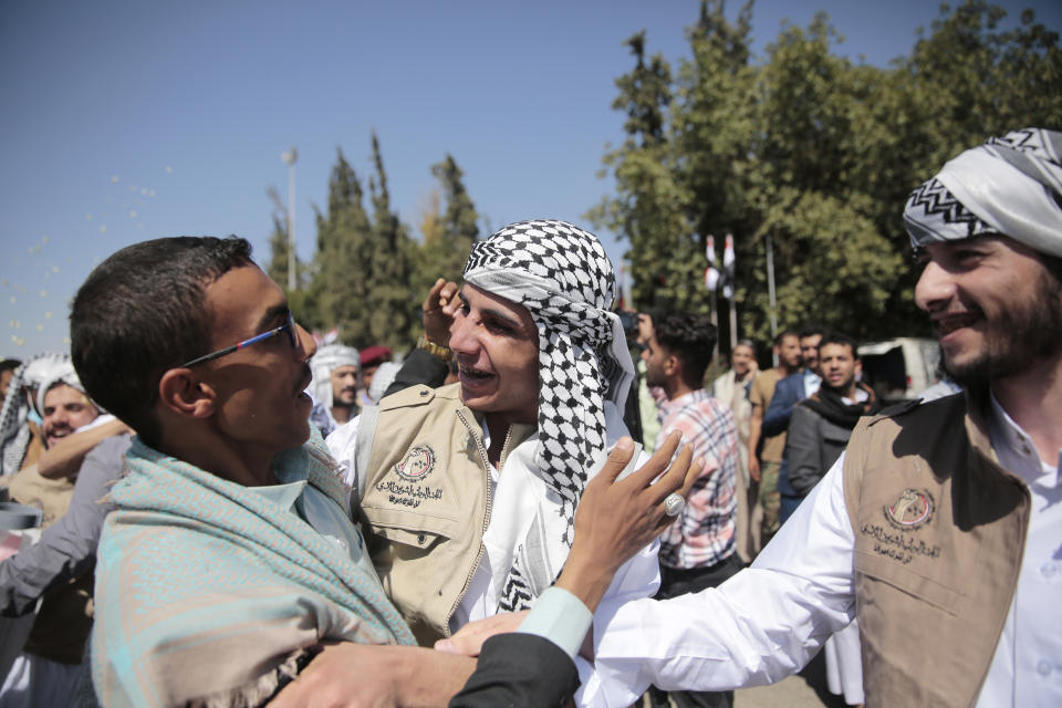 Yemeni prisoner are greeted by his relative after being released by the Saudi-led coalition, at the airport in Sanaa, Yemen, Thursday, Oct. 15, 2020. (AP Photo/Hani Mohammed)