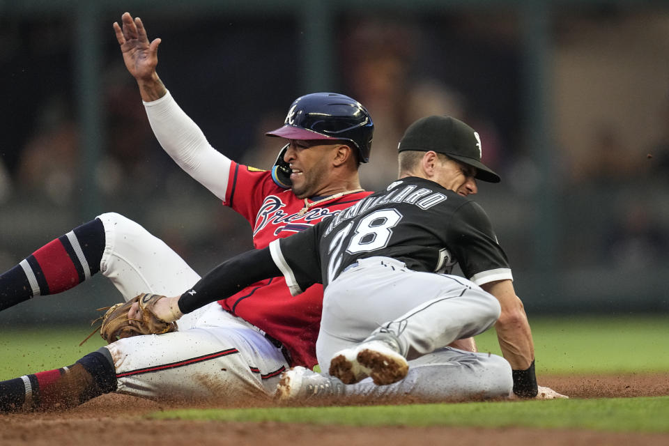 Atlanta Braves' Eddie Rosario is tagged out by Chicago White Sox shortstop Zach Remillard (28) as he tried to steal second base during the third inning of a baseball game Friday, July 14, 2023, in Atlanta. (AP Photo/John Bazemore)