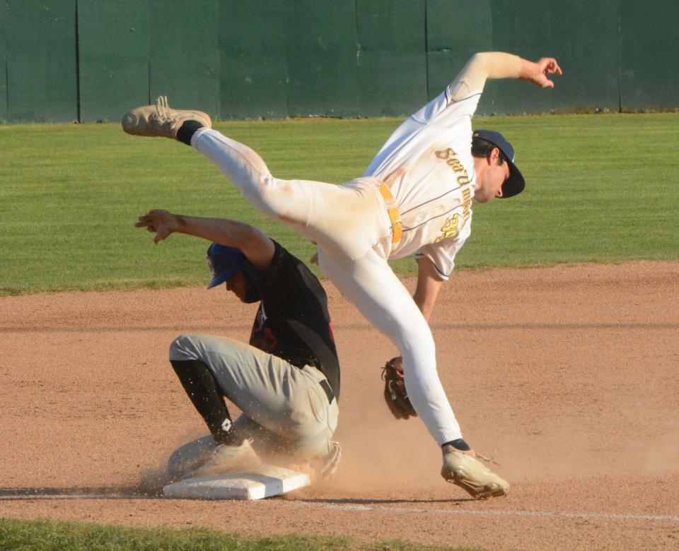 Norwich third baseman Dean Ferrara looks to make an acrobatic tag against Nashua on Sunday at Dodd Stadium.