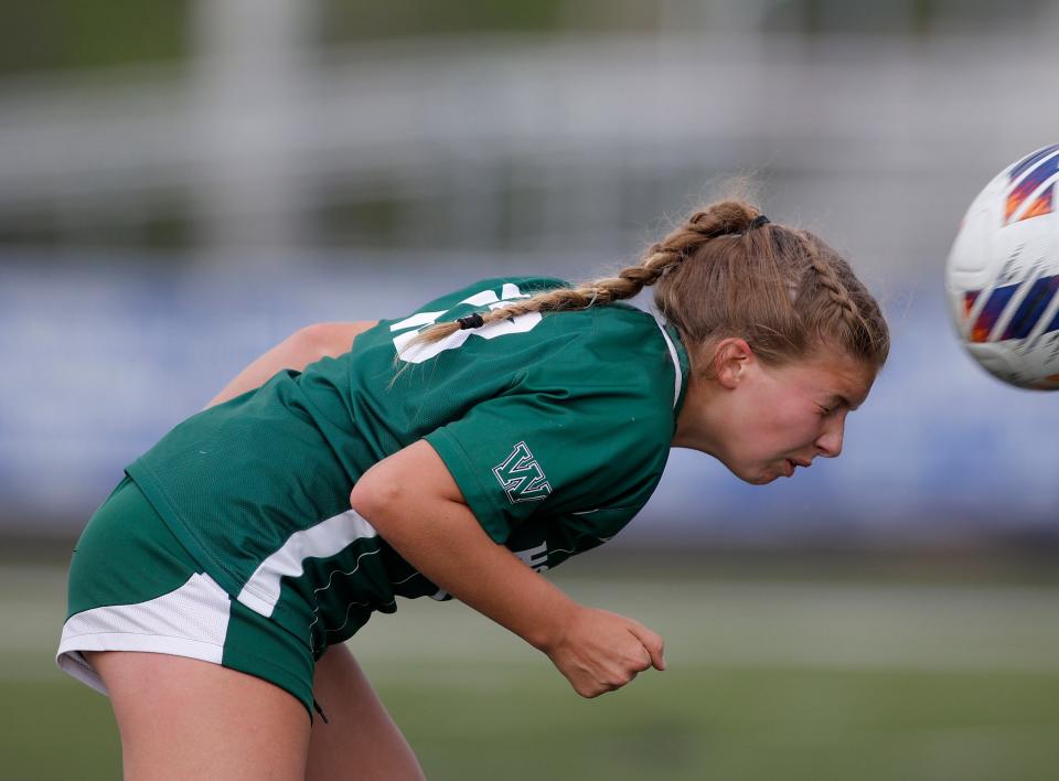 Williamston's Elly Gorsline heads the ball against Grosse Ile, Thursday, June 8, 2023, at Lansing Catholic High School.