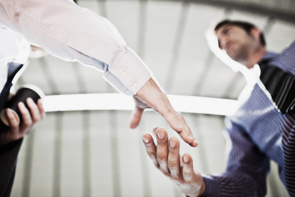 Two businessmen shake hands