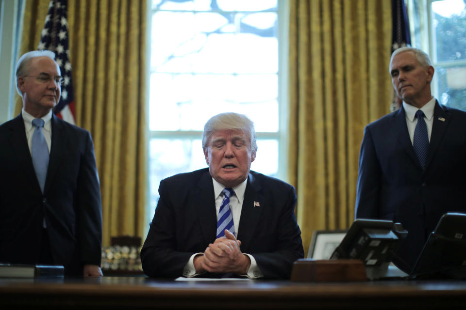 Trump talks to journalists at the Oval Office of the White House after the American Health Care Act&nbsp;was pulled before a vote. He is accompanied by U.S. Health and Human Services Secretary Tom Price, left, and Pence.