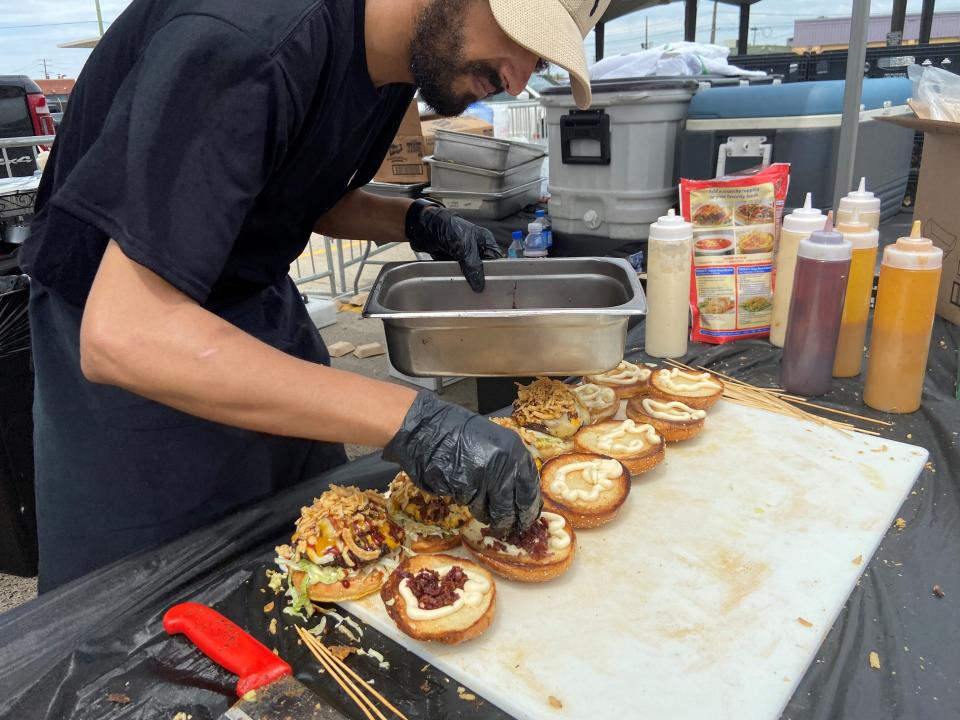 Aljoom's BBQ team member prepares burgers at the 2023 Detroit Burger Battle.