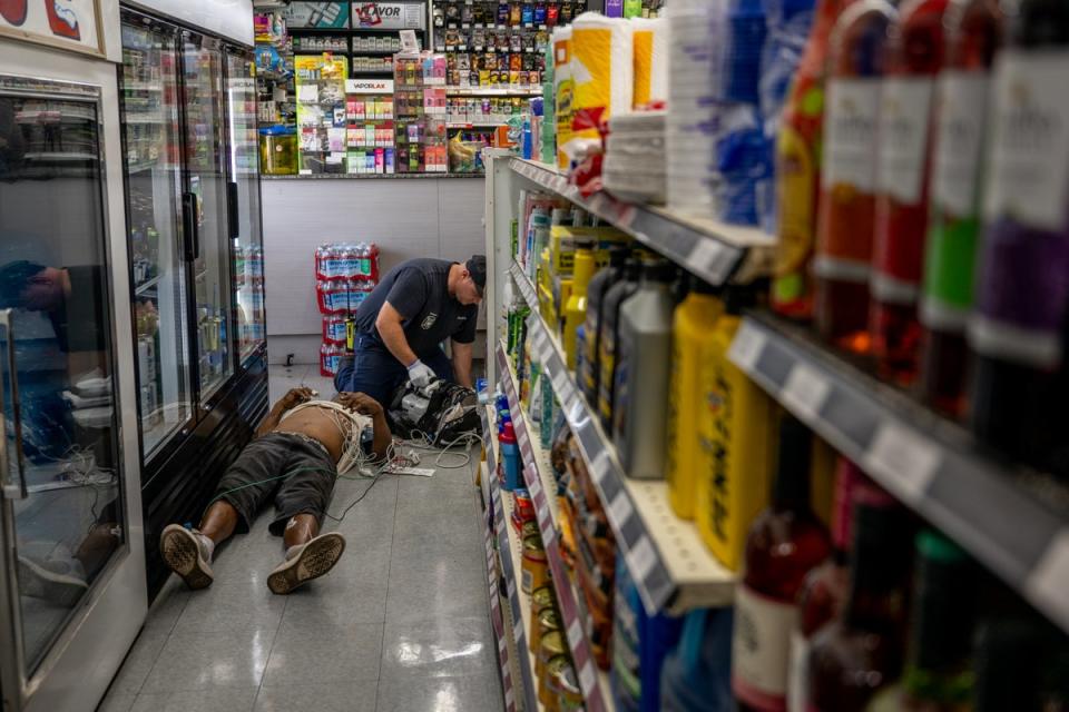 A person receives medical attention after collapsing in a convenience store on July 13, 2023 in Phoenix, Arizona. EMT was called after the person said they experienced hot flashes, dizziness, fatigue and chest pain. The temperature has been above 110F in Phoenix for most of July (Getty Images)