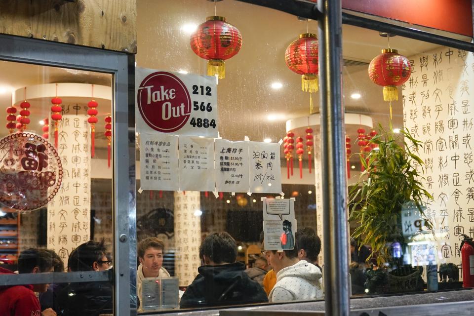 FILE - In this Feb. 12, 2021, file photo, people eat inside the New Shanghai Deluxe restaurant as indoor dining resumes in the Chinatown neighborhood of New York. States are beginning to ease coronavirus restrictions, but health experts say we don’t know enough yet about variants to roll back measures that could help slow their spread. (AP Photo/Frank Franklin II, File)