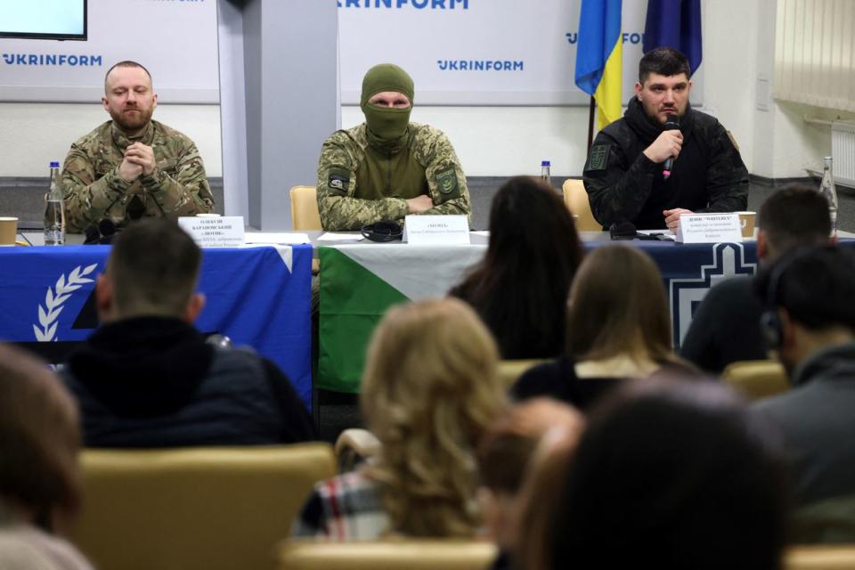 Oleksiy Baranovsky, Freedom of Russia Legion volunteer (L), a masked fighter with the Siberian Battalion (C), and the commander and founder of the Russian Volunteer Corps, Denis Kapustin (R), take part in the press conference on behalf of the Russian Liberation Forces fighting on the Ukrainian side, in Kyiv on March 21, 2024, amid the Russian invasion of Ukraine. (Anatolii Stepanov/AFP via Getty Images)