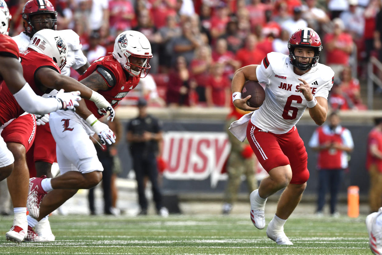 Jacksonville State quarterback Tyler Huff (6) attempts to get a first down during the first half of an NCAA college football game against Louisville in Louisville, Ky., Saturday, Sept. 7, 2024. (AP Photo/Timothy D. Easley)