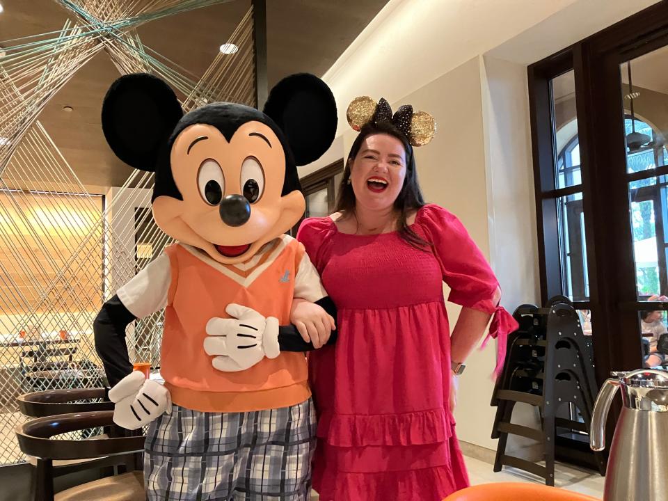 megan posing with mickey mouse at ravello in the four seasons resort at disney world