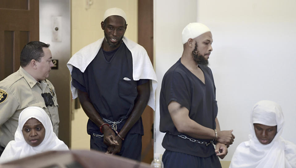 Defendants, from left, Jany Leveille, Lucas Morton, Siraj Wahhaj and Subbannah Wahhaj enter district court in Taos, N.M., for a detention hearing, Monday, Aug. 13, 2018. Several defendants have been charged with child abuse stemming from the alleged neglect of 11 children found living on a squalid compound on the outskirts of tiny Amalia, New Mexico. (Roberto E. Rosales/The Albuquerque Journal via AP, Pool)