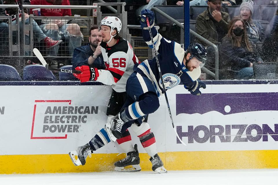 Feb 14, 2023; Columbus, Ohio, USA;  Columbus Blue Jackets center Sean Kuraly (7) hits New Jersey Devils left wing Erik Haula (56) during the first period of the NHL hockey game at Nationwide Arena. Mandatory Credit: Adam Cairns-The Columbus Dispatch