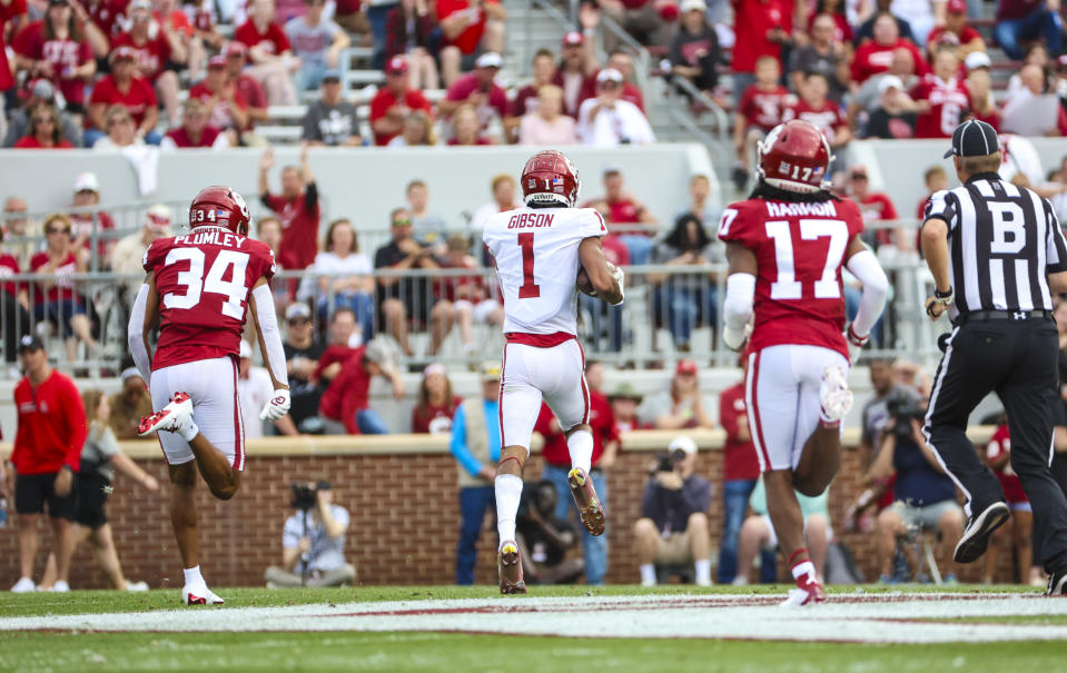 April 23, 2022; Norman; Oklahoma Sooners wide receiver Jayden Gibson (1) scores a touchdown past defensive back Dorian Plumley (34) and defensive back Damond Harmon (17) during the spring game at Gaylord Family Oklahoma Memorial Stadium. Kevin Jairaj-USA TODAY Sports