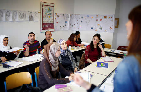 Migrants attend a lesson at the "institute for intercultural communication" in Berlin, Germany, April 13, 2016. REUTERS/Hannibal Hanschke