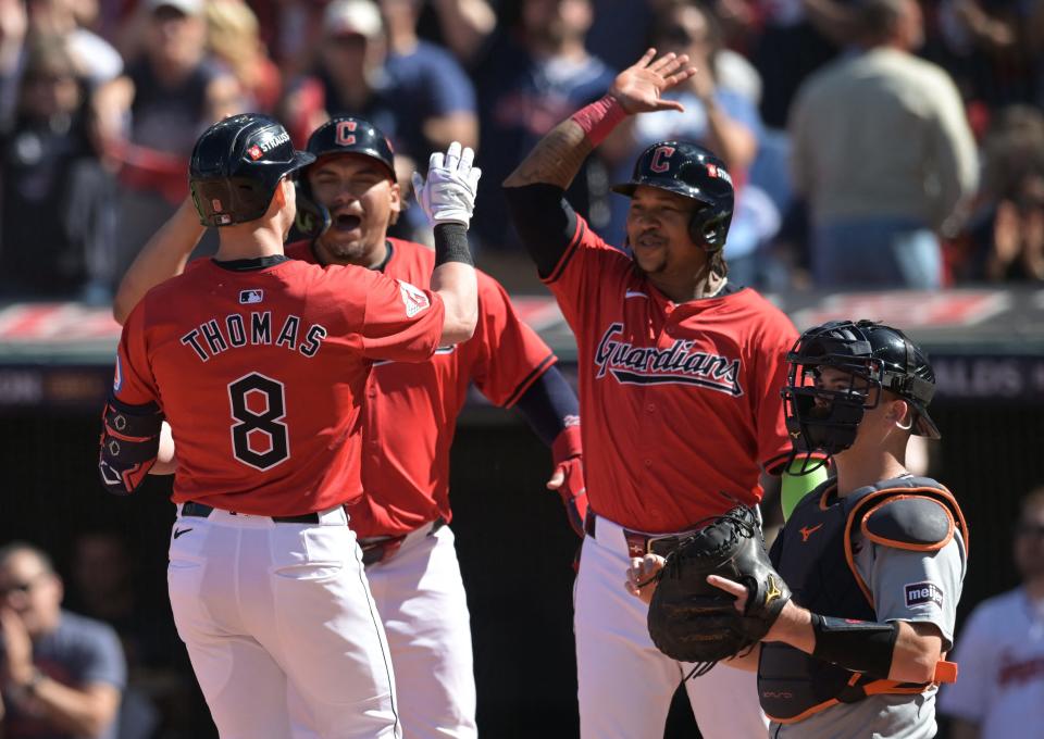 Guardians outfielder Lane Thomas celebrates with teammates after hitting a three-run home run against the Detroit Tigers in the first inning in Game 1 of the ALDS, Oct. 5, 2024, in Cleveland.