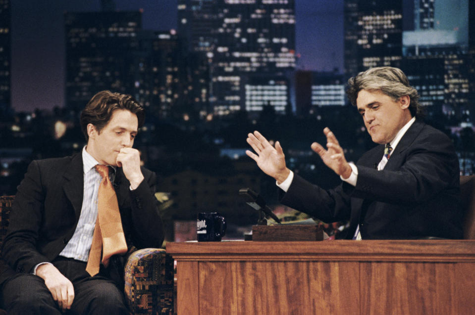 This July 10, 1995 photo released by NBC shows actor Hugh Grant, left, during an interview with host Jay Leno on "The Tonight Show with Jay Leno," in Burbank, Calif., two weeks after Grant's highly publicized arrest for picking up a prostitute. After 22 years, Leno will host his last show on Thursday, Feb. 6, 2014. (AP Photo/NBC, Margaret Norton)