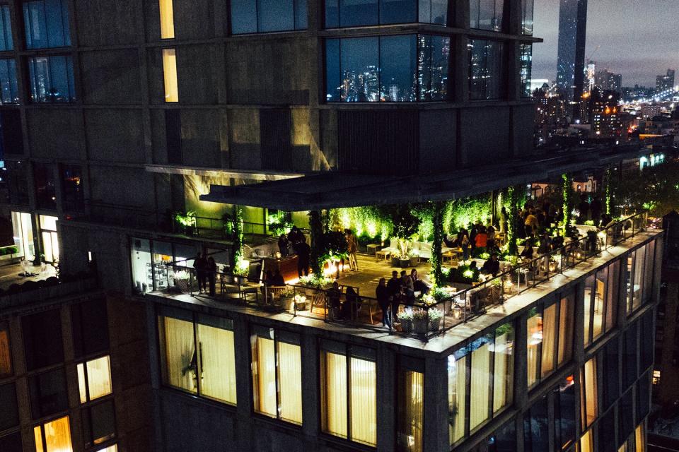 Exterior view of the PUBLIC hotel and rooftop at night