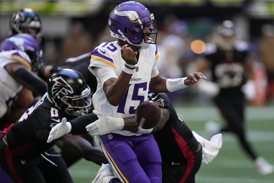 Minnesota Vikings quarterback Joshua Dobbs (15) fumbles the ball during the first half of an NFL football game against the Atlanta Falcons, Sunday, Nov. 5, 2023, in Atlanta. The ball was recovered by the Falcons. (AP Photo/Mike Stewart)