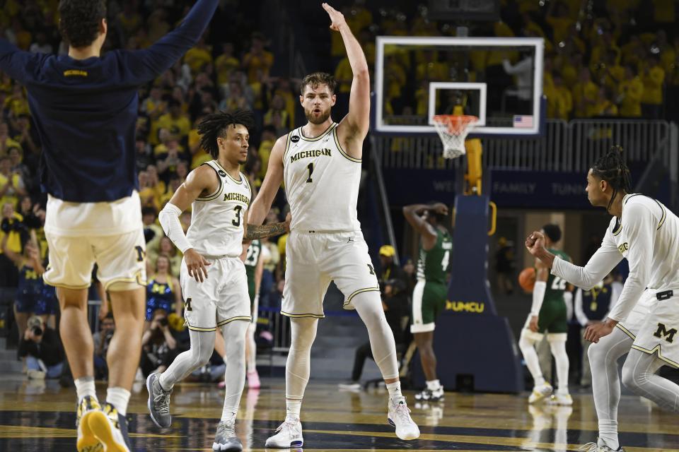 Michigan center Hunter Dickinson reacts after making a 3-point basket as time expired in the first half on Sunday, Nov. 20, 2022, at Crisler Center.