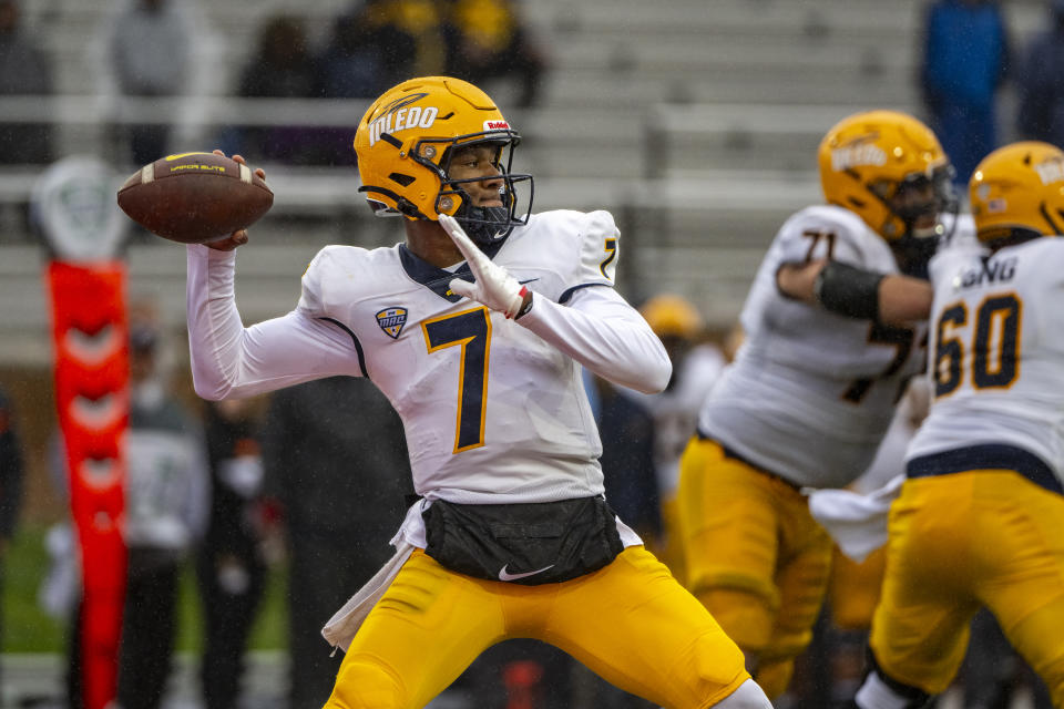 FILE - Toledo quarterback Dequan Finn (7) prepares to throw during an NCAA football game against Ball State on Saturday, Oct. 14, 2023, in Muncie, Ind. No. 23 Toledo, ranked in the AP Top 25 poll for the first time since 2015, will visit Central Michigan on Friday with a chance to accomplish some rarities for a Mid-American Conference team. With a win over the Chippewas in the regular-season finale, the Rockets (10-1, 7-0 MAC) can become the first school to go 8-0 in the MAC since 2016 and keep themselves in the conversation to earn a possible berth in the New Year's Six bowl lineup. (AP Photo/Doug McSchooler, File)