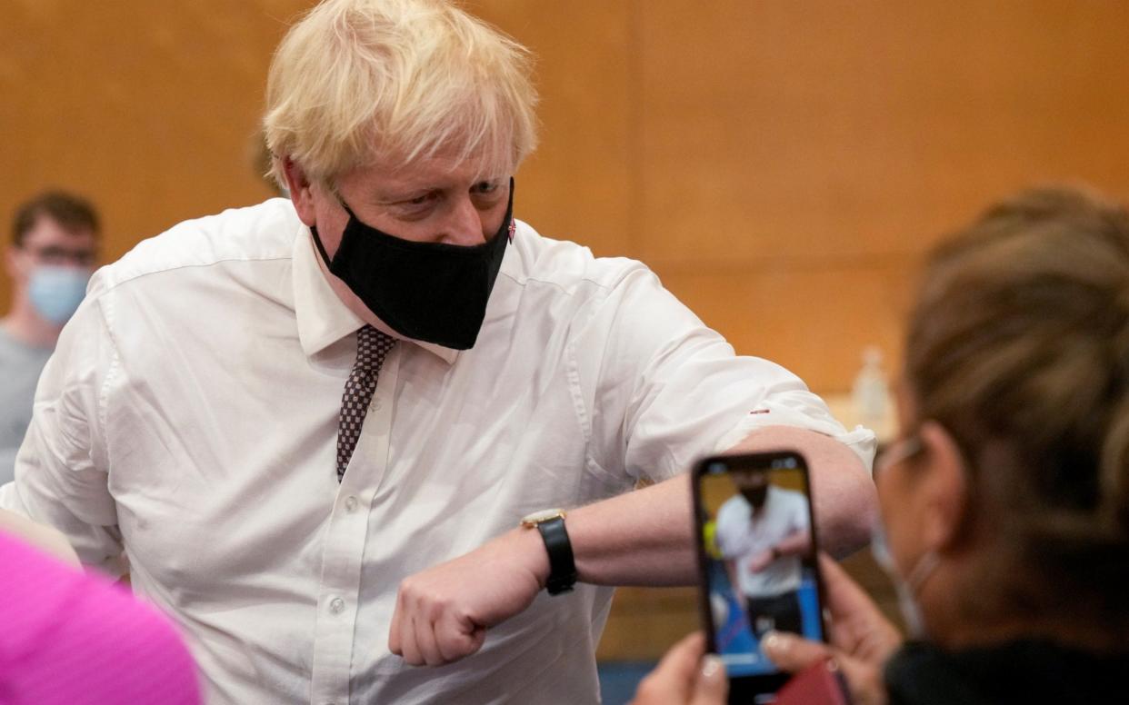 Boris Johnson ruled out any further lockdowns on a visit to a vaccine centre today, but said mitigations such as working from home remain "under review" - Matt Dunham/Pool via Reuters