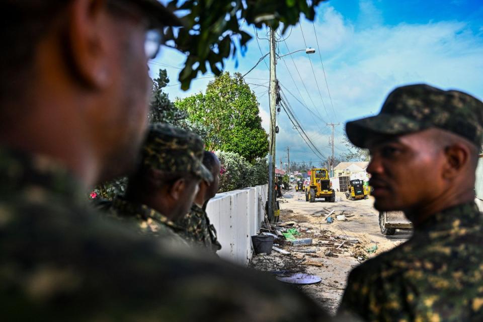 Members of Barbados National Armed Forces clear a street of sand as it gets flooded by sea water after the passage of Hurricane Beryl in Oistins, Barbados on July 1, 2024.<span class="copyright">Chandan Khanna—AFP/Getty Images</span>