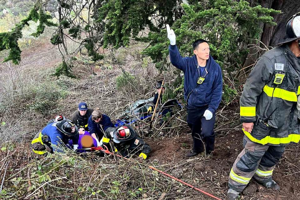 <p>San Francisco Fire Department Media/X</p> San Francisco fire crews rescue two people whose car rolled down an embankment