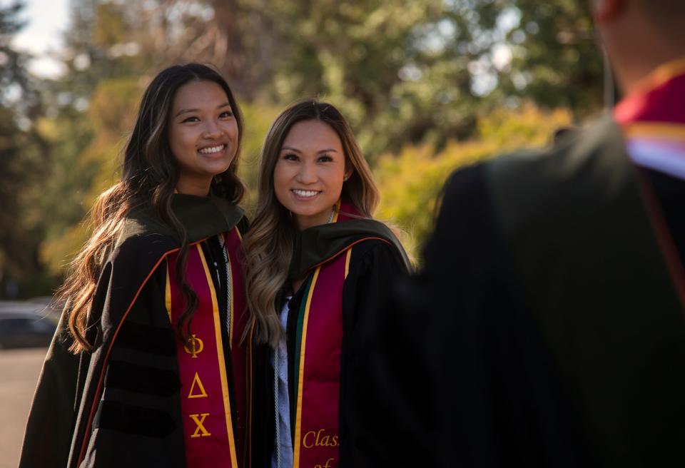 University of the Pacific graduating students Erica Chang, left, and Natalyne Ho take a portrait near the Pacific Gate in front of the university's campus on Wednesday in Stockton. Pacific's commencement is 10 a.m. Saturday.